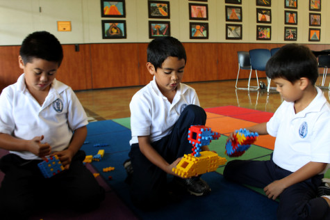 Second graders Hanale Kauha'aha'a and Kaleikaumaka Roback, along with first-grader Errol Sheehan, play with toys at the Kamehameha Schools After School Program. They find that toys are "what's cool." Photo by Maile Sur.